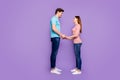 Full length profile photo of cute guy lady couple stand opposite hold hands look eyes love confession wear casual blue Royalty Free Stock Photo