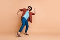 Full length profile photo of guy dance open mouth wear glasses brown t-shirt trousers shoes isolated beige color