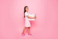 Full length profile photo of little lady hands hold giftbox holidays guest going have fun wear sun dress isolated pink