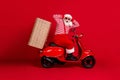 Full length profile photo of retired old man scooter ride deliver pizza box late hands head wear santa x-mas costume