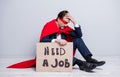 Full length profile photo of stressed mature dismissed business guy super hero costume hold placard need work sit floor
