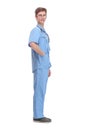 Full length profile shot of a young male doctor in a blue uniform standing and waiting Royalty Free Stock Photo