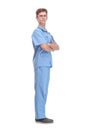 Full length profile shot of a young male doctor in a blue uniform standing and waiting Royalty Free Stock Photo