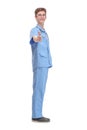 Full length profile shot of a young male doctor in a blue uniform standing and waiting Royalty Free Stock Photo