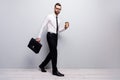 Full length profile side photo marketer economist man go walk morning partnership meeting hold beverage mug leather bag