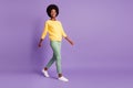 Full length profile side photo of positive afro ameriacn girl go empty space isolated over purple color background Royalty Free Stock Photo