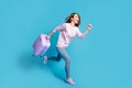 Full length profile side photo of positive girl enjoy quarantine corona virus borders open hold baggage run travel trip Royalty Free Stock Photo