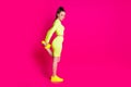 Full length profile side photo of sport girl stretch legs empty space wear yellow gumshoes isolated on pink bright color