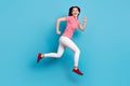 Full length profile side photo of young girl happy positive smile jump go run hurry sale isolated over blue color