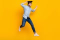 Full length profile side photo of young man happy positive smile jump go run master degree isolated over yellow color