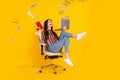 Full length profile side photo of young woman happy positive smile throw money dollars laptop isolated over yellow color Royalty Free Stock Photo