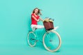 Full length profile side photo of young woman happy smile ride bicycle trip transport isolated over turquoise color Royalty Free Stock Photo