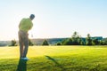 Experienced male golfer hitting the golf ball towards the cup Royalty Free Stock Photo