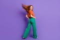 Full length rear view photo of positive pretty carefree girl wear trendy collection clothes isolated on purple color Royalty Free Stock Photo