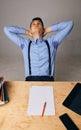 A relaxed confident young businessman sitting with legs on desk at office Royalty Free Stock Photo