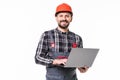 Repairman in hemlet using laptop against white background Royalty Free Stock Photo