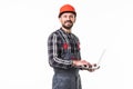 Repairman in hemlet using laptop against white background Royalty Free Stock Photo