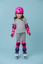 Full-length roller skating girl in protective gear