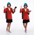 Full length 20s young Asian engineer architect Woman wear hardhat, thinking work hard Royalty Free Stock Photo