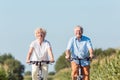 Senior couple looking forward with confidence while riding bicyc