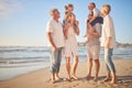 Full length of a senior caucasian couple at the beach with their children and grandchild. Happy family relaxing on the Royalty Free Stock Photo