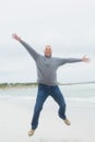 Full length of a senior man jumping at beach Royalty Free Stock Photo