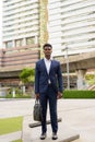 Full length shot of African businessman outdoors in city Royalty Free Stock Photo