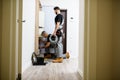 Full length shot of aged electrician, repairman in uniform working, installing ethernet cable or router in fuse box