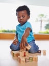 Having fun and learning all in one. Full length shot of a baby boy playing with building blocks at home. Royalty Free Stock Photo