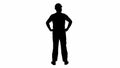 Silhouette Engineer in construction helmet standing with hands on hips looking around. Royalty Free Stock Photo