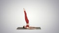 Beautiful sporty girl doing yoga exercises for abs strength, Supported Shoulderstand asana, Salamba Sarvangasana on