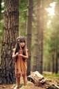 Embracing her heritage. Full length shot of a cute little girl playing dressup in the woods.