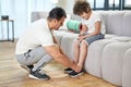 Full length shot of dad tying the laces on a child sneakers while getting ready for workout at home Royalty Free Stock Photo