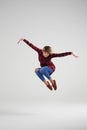 Delighted young girl in casual clothes jumping at studio Royalty Free Stock Photo