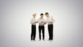 Three similar dressed guys reading some documents while one of t Royalty Free Stock Photo