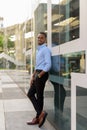 Full length shot of handsome black African businessman outdoors in city during summer Royalty Free Stock Photo