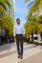 Full length shot of handsome black African businessman outdoors in city during summer Royalty Free Stock Photo