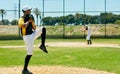 Putting his pitching skills to work. Full length shot of a handsome young baseball player pitching a ball during a match Royalty Free Stock Photo