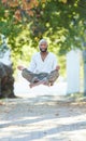 Yogas got him floating. Full length shot of a handsome young man levitating while meditating outside at the park. Royalty Free Stock Photo