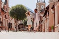 Full length shot of happy multiracial couple holding handsand walking on the street together Royalty Free Stock Photo