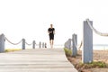 Full length shot of healthy young man running on the promenade. Male runner sprinting outdoors Royalty Free Stock Photo