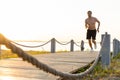 Full length shot of healthy young man running on the promenade. Male runner sprinting outdoors Royalty Free Stock Photo