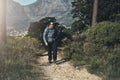 I swear I just heard something move in the bushes. Full length shot of a middle aged man hiking in the mountains. Royalty Free Stock Photo