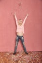 Full length shot, one young happy, smiling woman arms outstretched high in air with confetti falling down on floor Royalty Free Stock Photo
