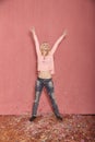 Full length shot, one young happy, smiling woman arms outstretched high in air with confetti falling down on floor Royalty Free Stock Photo