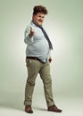 Nudge, nudge, wink, wink. Full length shot of an overweight man pointing at the camera. Royalty Free Stock Photo