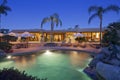 View across a pool to patio of luxury home Royalty Free Stock Photo