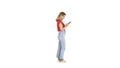 Casual young woman typing on mobile phone on white background. Royalty Free Stock Photo