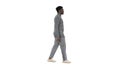 Young african american man in grey casual clothes walking on whi Royalty Free Stock Photo