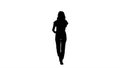 Silhouette Woman in casual walking and talking on the phone. Royalty Free Stock Photo